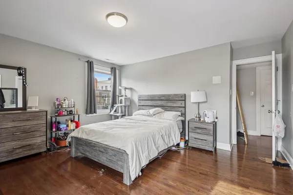 a bedroom with a bed and a dresser