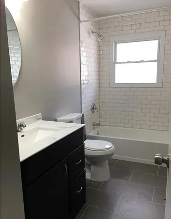 a bathroom with a double vanity sink toilet and shower