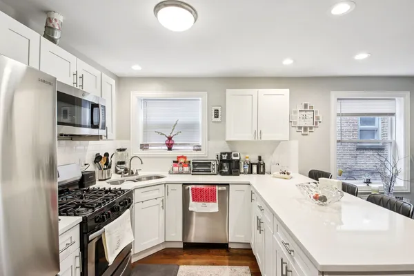 a kitchen with a sink stove top oven and refrigerator