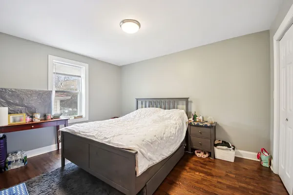 a bed sitting in a bedroom next to a window