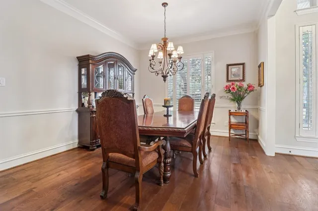 a view of a dining room with furniture wooden floor and chandelier