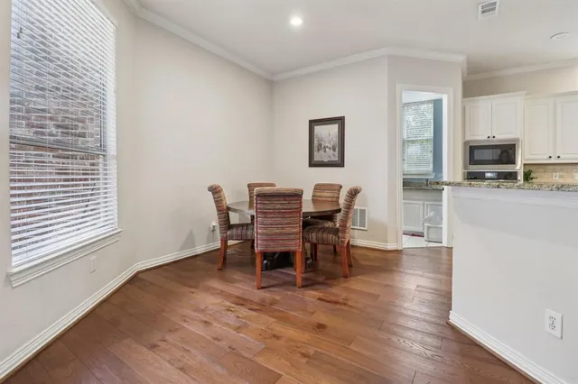 a dining room with furniture and wooden floor