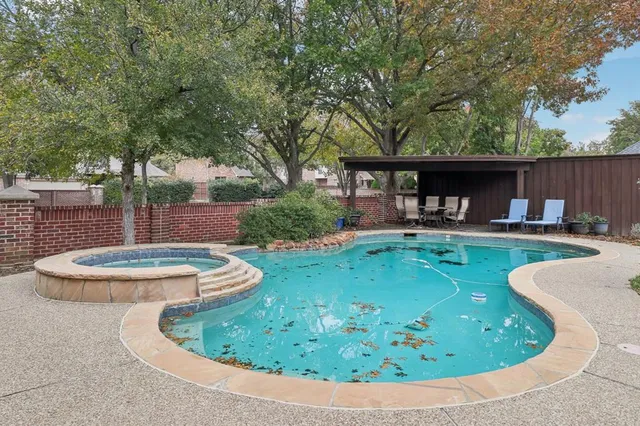a swimming pool with outdoor seating and yard