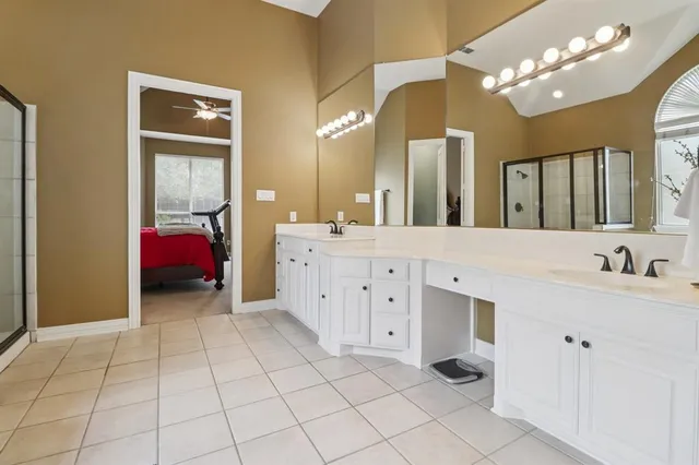 a bathroom with a sink vanity and mirror