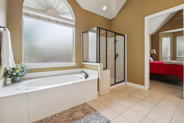 a spacious bathroom with a bathtub and shower