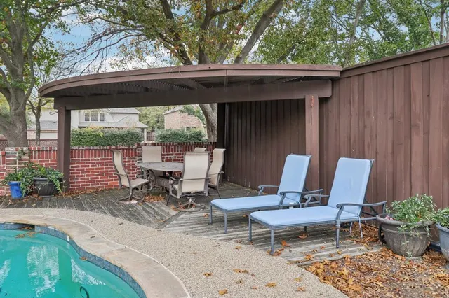 a view of two chairs in the patio