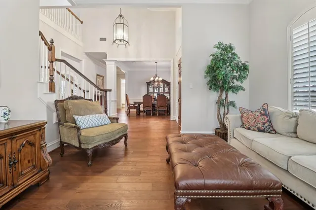 a living room with furniture and a chandelier