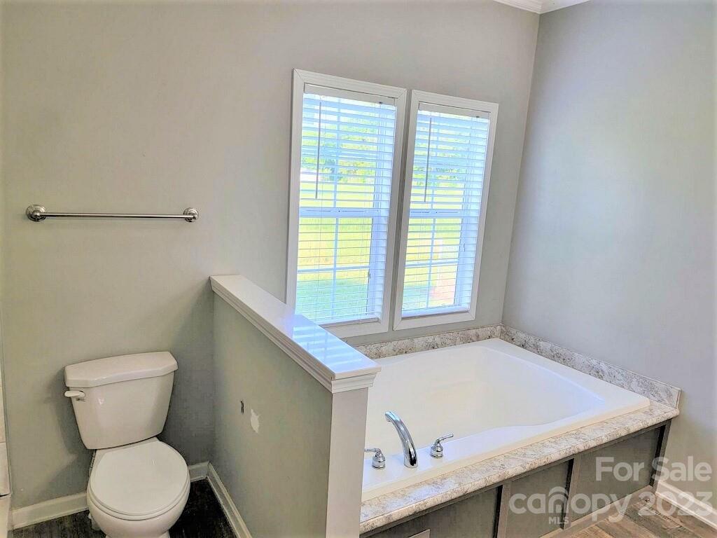 3230 Sorrells Baxter Road Cherryville, NC 28021 - Photo 11 of 29 a bathroom with a granite countertop sink and a toilet