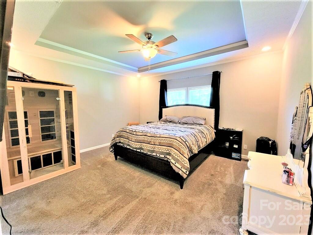 3230 Sorrells Baxter Road Cherryville, NC 28021 - Photo 14 of 29 a bedroom with a bed and a chandelier