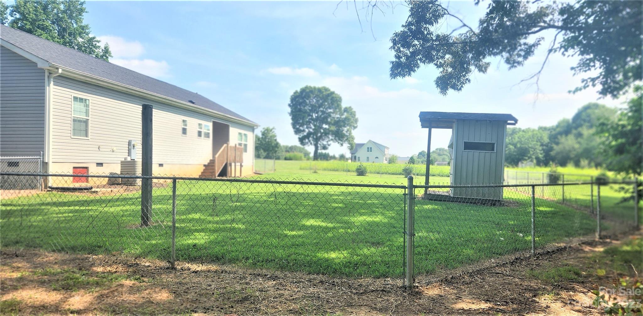 3230 Sorrells Baxter Road Cherryville, NC 28021 - Photo 3 of 29 a view of a white house in a big yard with large trees
