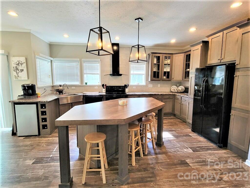 3230 Sorrells Baxter Road Cherryville, NC 28021 - Photo 6 of 29 a kitchen with stainless steel appliances kitchen island granite countertop a sink a stove and chairs