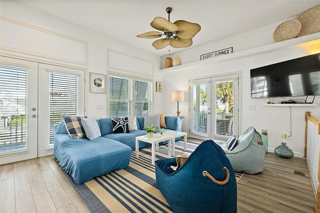 a living room with furniture a flat screen tv and a large window