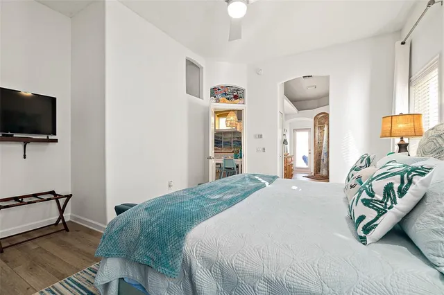 a bedroom with a bed and a flat screen tv