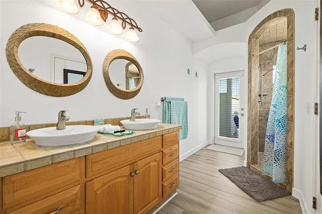 a bathroom with a granite countertop sink and a mirror