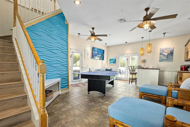a view of a livingroom with furniture and a ceiling fan
