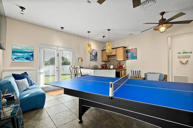 a living room with furniture and kitchen view