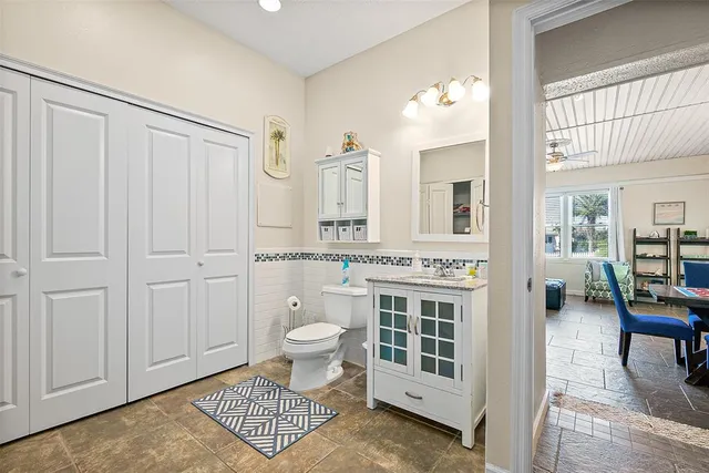 a bathroom with a toilet a sink and a mirror