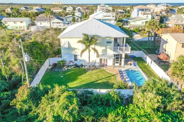 a view of a house with swimming pool and sitting area