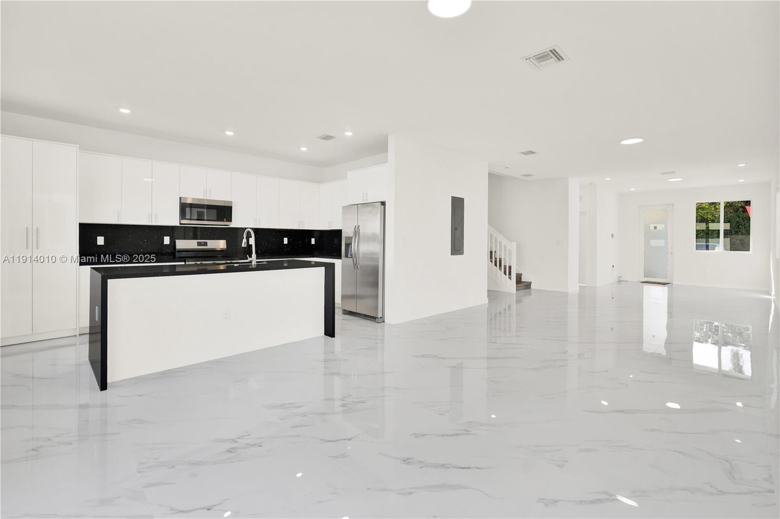 22535 Southwest 125th Avenue, Unit 22535 Miami, FL 33170 - Photo 12 of 35 a kitchen with stainless steel appliances granite countertop a stove a sink and a refrigerator