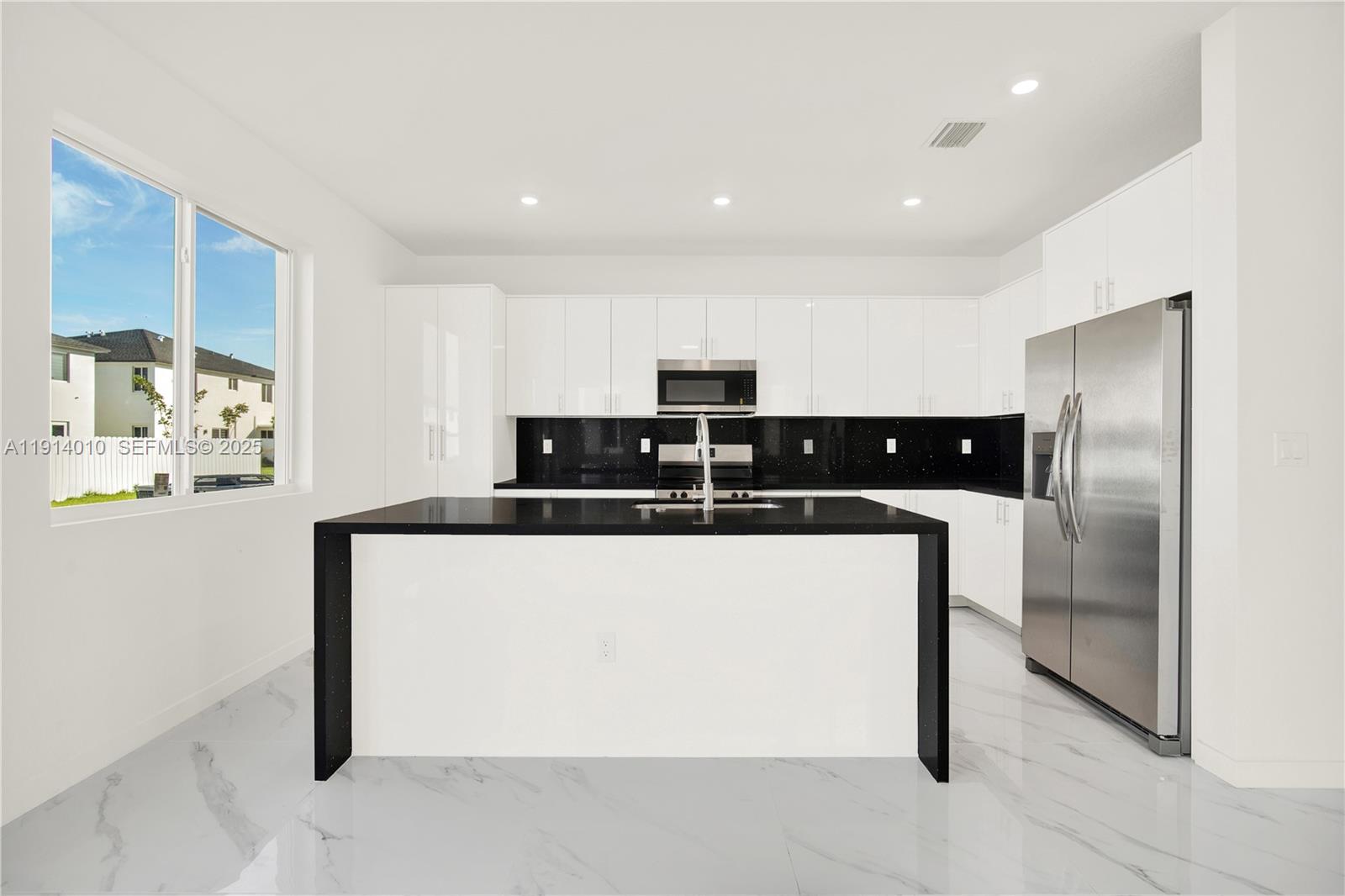 22535 Southwest 125th Avenue, Unit 22535 Miami, FL 33170 - Photo 13 of 35 a kitchen with stainless steel appliances kitchen island granite countertop a refrigerator and a sink