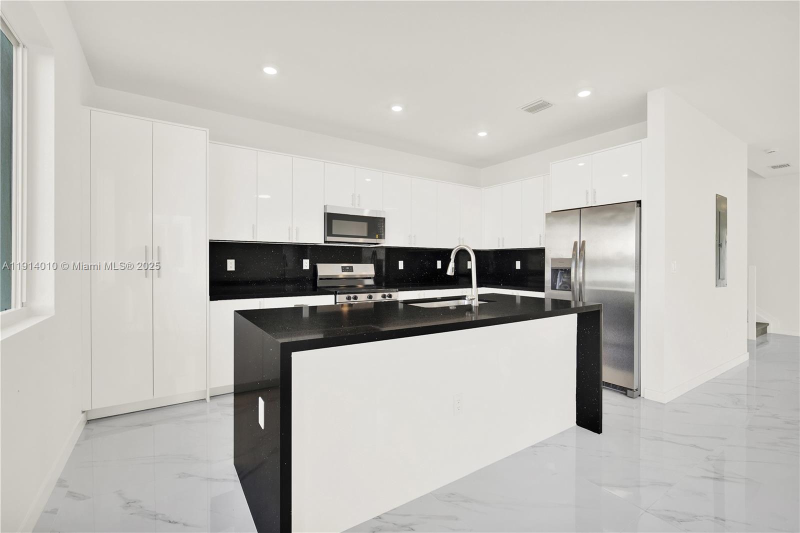 22535 Southwest 125th Avenue, Unit 22535 Miami, FL 33170 - Photo 14 of 35 a kitchen with stainless steel appliances a refrigerator and a stove top oven