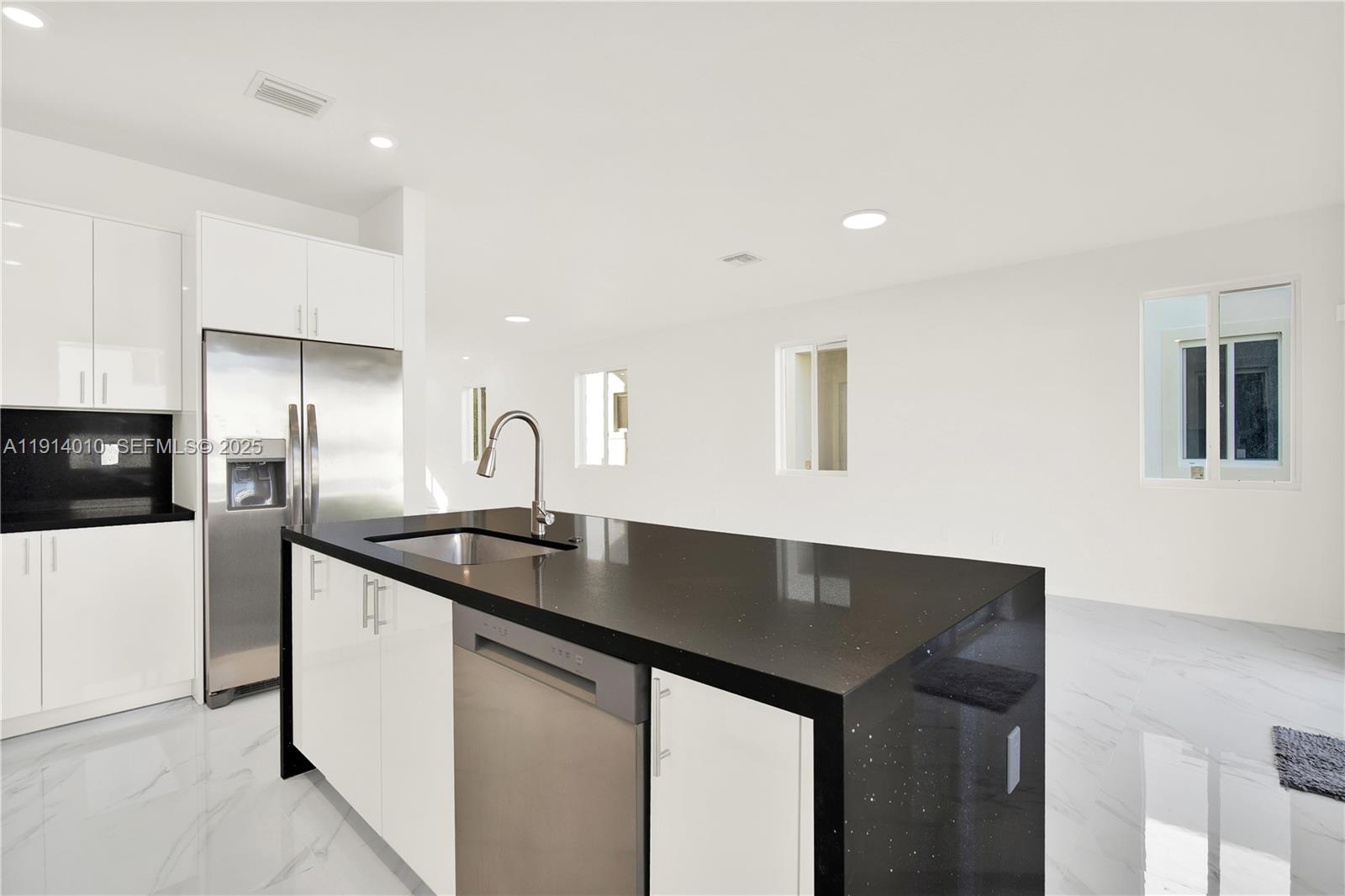 22535 Southwest 125th Avenue, Unit 22535 Miami, FL 33170 - Photo 16 of 35 a kitchen with granite countertop a sink and a refrigerator