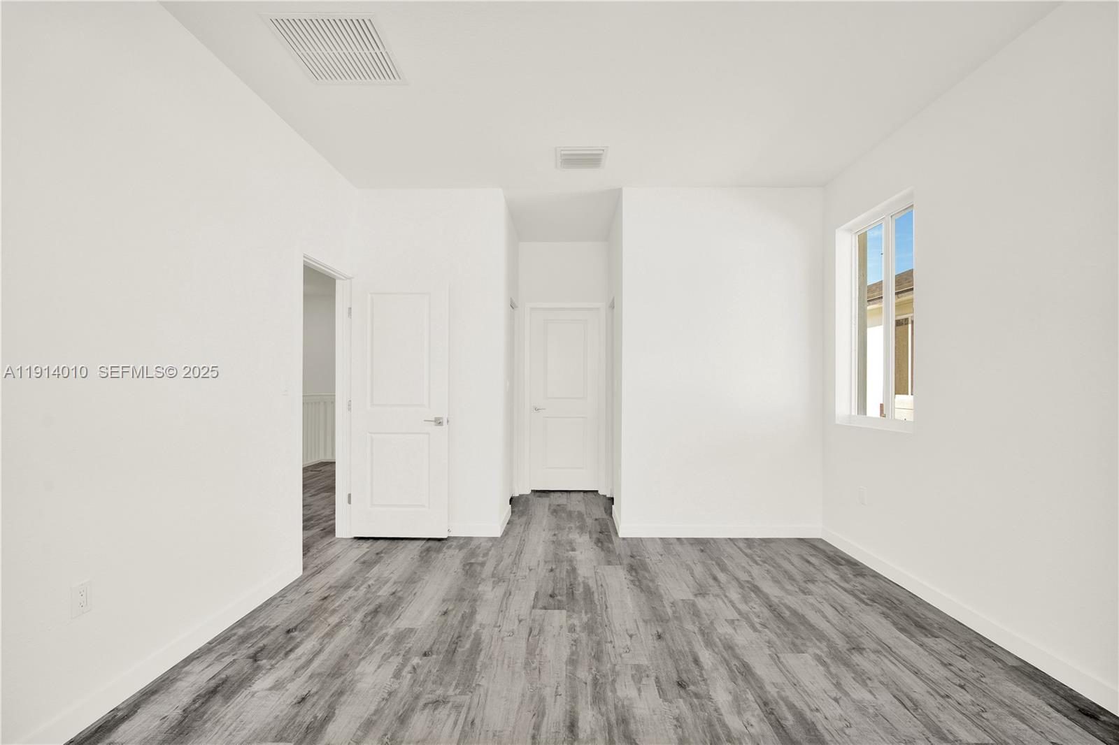 22535 Southwest 125th Avenue, Unit 22535 Miami, FL 33170 - Photo 23 of 35 a view of a room with wooden floor and a window