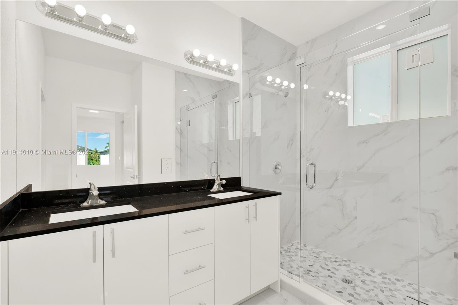 22535 Southwest 125th Avenue, Unit 22535 Miami, FL 33170 - Photo 25 of 35 a bathroom with a granite countertop sink a shower and a mirror