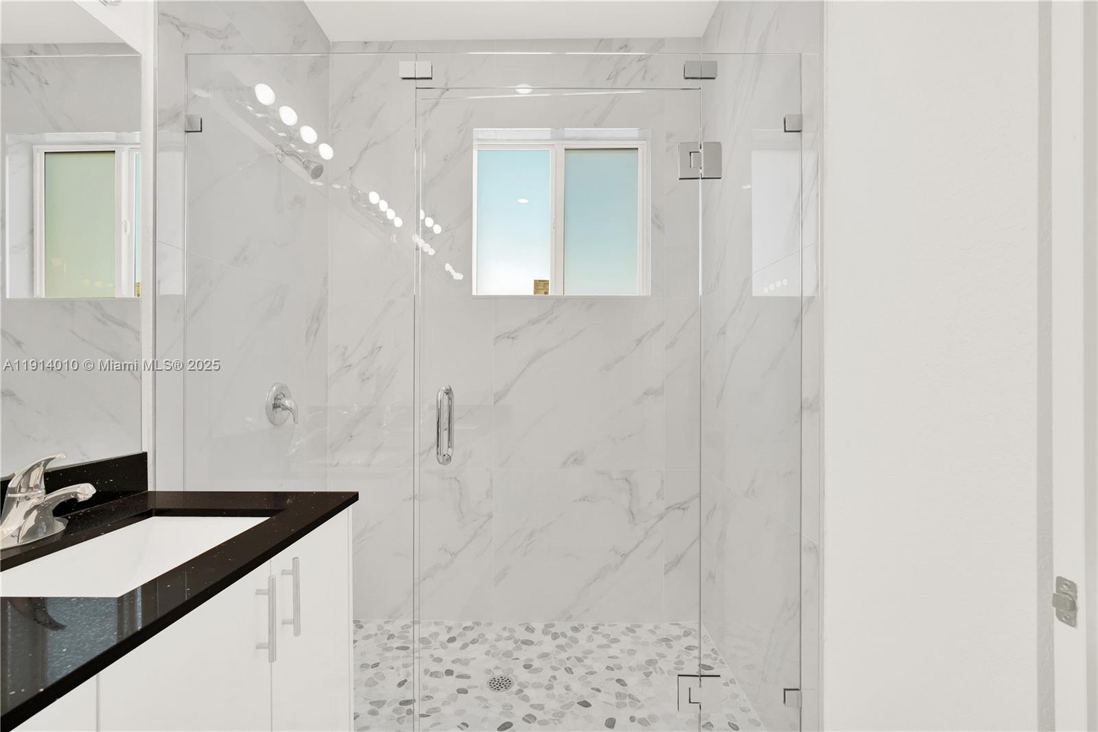 22535 Southwest 125th Avenue, Unit 22535 Miami, FL 33170 - Photo 26 of 35 a bathroom with a granite countertop sink a toilet a mirror and shower