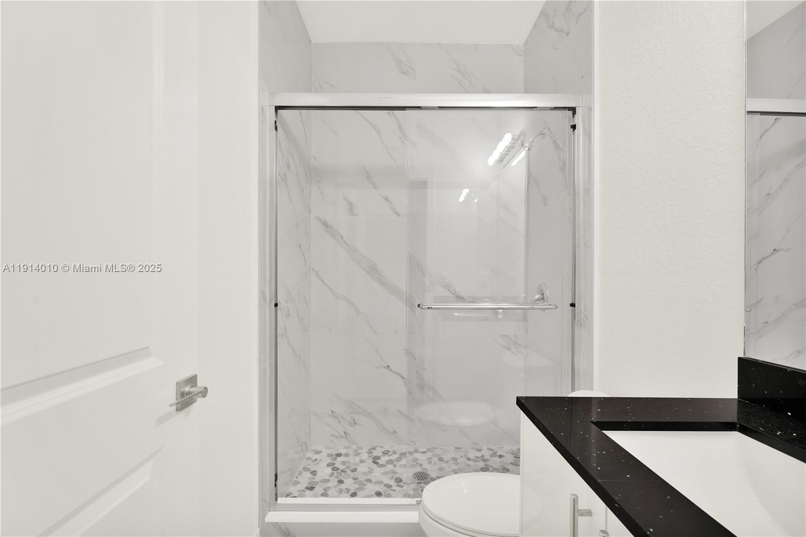 22535 Southwest 125th Avenue, Unit 22535 Miami, FL 33170 - Photo 28 of 35 a bathroom with a granite countertop sink toilet and shower