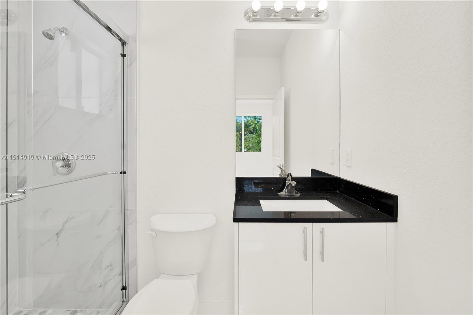 22535 Southwest 125th Avenue, Unit 22535 Miami, FL 33170 - Photo 32 of 35 a bathroom with a granite countertop sink a toilet and shower