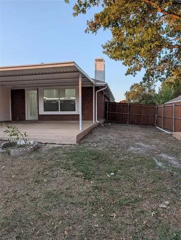a view of a kitchen with wooden floor and electronic appliances