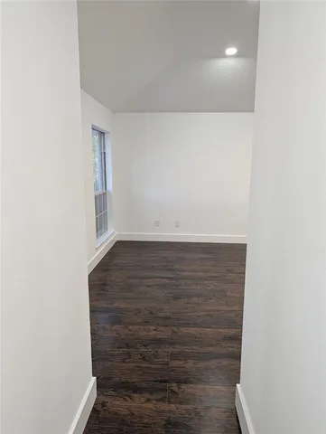 a view of a kitchen with a sink and a refrigerator
