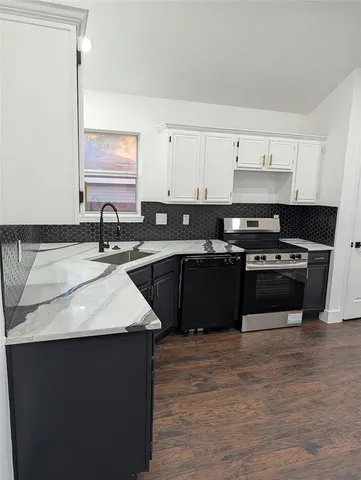 a kitchen with a sink and a stove