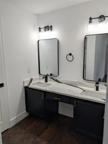a bathroom with a double vanity sink and a mirror