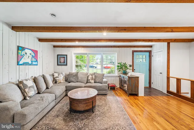 a living room with furniture a rug and a window