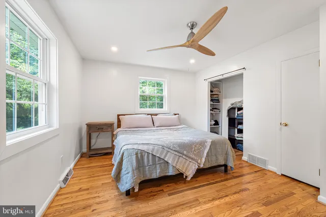 a bedroom with a large bed and a large window