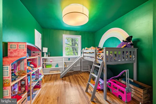 a bathroom with a granite countertop toilet sink and mirror