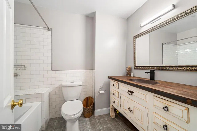 a bedroom with a bed a book shelf and a window