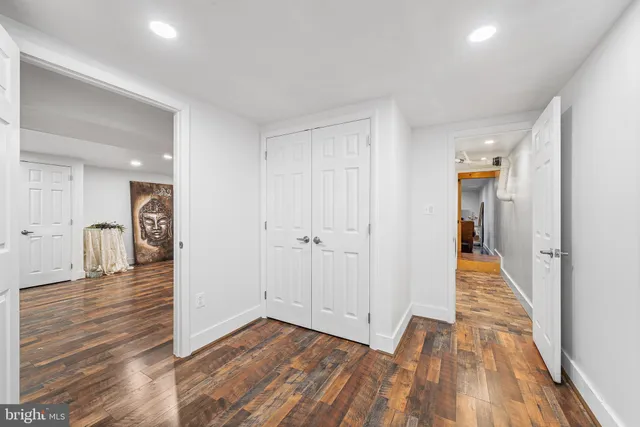 a kitchen with stainless steel appliances kitchen island granite countertop a table and chairs in it