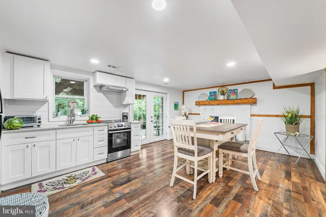 a bathroom with a sink a toilet and a mirror