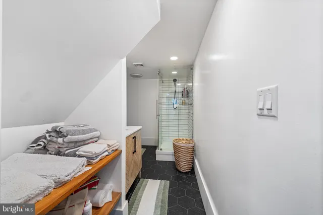 a spacious bedroom with a bed and a large window