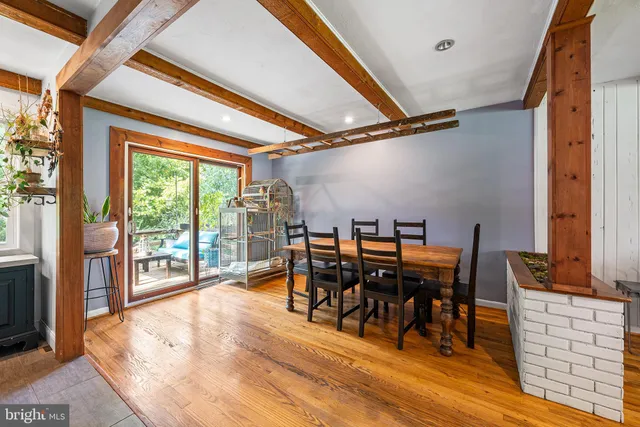 a dining room with furniture water view and wooden floor