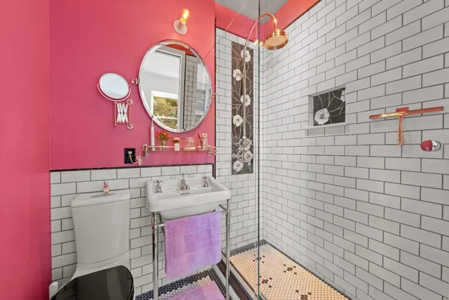 a bathroom with a sink mirror and toilet