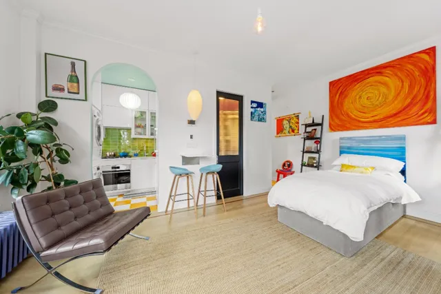 a bedroom with a bed and a couch