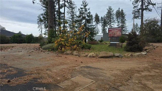 a view of a dirt road with a building in the background