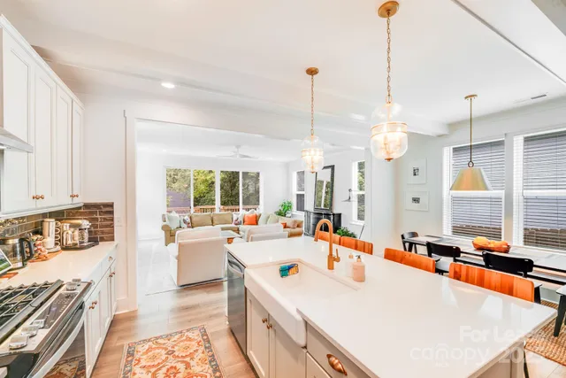 a large white kitchen with a large window