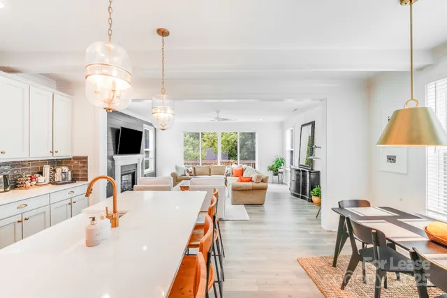 a very nice looking living room with a large window and dining table