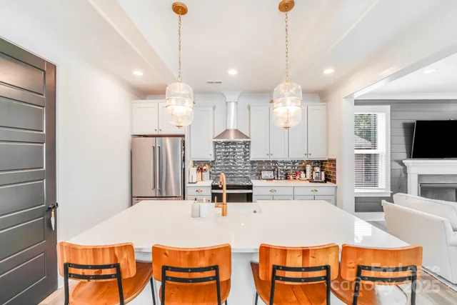 a large kitchen with a table and chairs