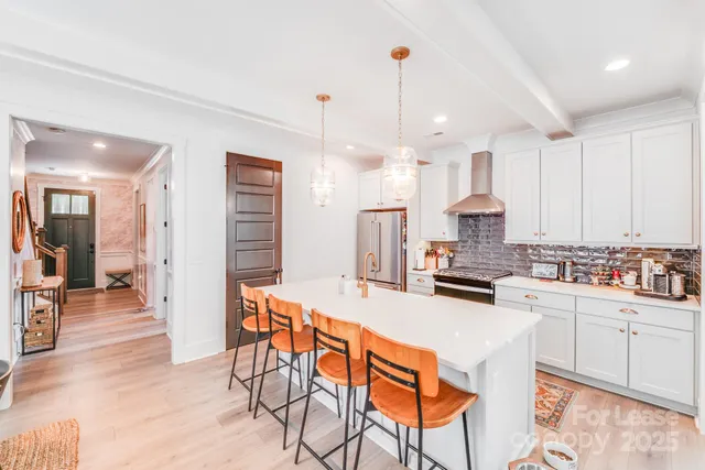 a kitchen with stainless steel appliances a stove a sink a refrigerator and cabinets